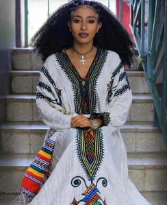 An Amhara woman (Agaw Cushitic origin). Although the Amhara and Tigray-Tigrinya today speak Semitic languages, they are genetically, physically and culturally most similar to the Cushitic-speaking Agaws, who live right beside them in the Ethiopian and Eritrean highlands. Genome analysis indicates that, like Agaws and other Cushitic speakers, the Amhara and other Abyssinians/Habesha predominantly bear non-African ancestry (over 70% on average), of which the Levantine Natufian component constitutes a major element. This suggests that Amhara and Tigray-Tigrinya originally spoke Cushitic Agaw languages and adopted their present Semitic tongues from Sabaean outsiders. Consequently, the Amharic and Tigrinya languages today both have an Agaw substratum, which was retained from the Cushitic languages that the Amhara's and Tigray-Tigrinya's Agaw ancestors originally spoke. (N.B. Although Abyssinians/Habesha are of Cushitic Agaw origin, they are genetically differentiated from the Agaw proper by having greater East African hunter-gatherer and peninsular Arab influences. For the Amhara, these admixtures are estimated at 16% apiece by Hodgson et al. (2014) (cf. Table 2 and Table S6).)